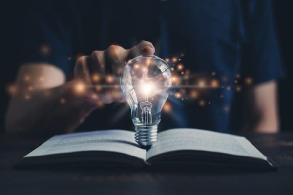 lampadina-toccata-da-studente-con-libro-aperto
